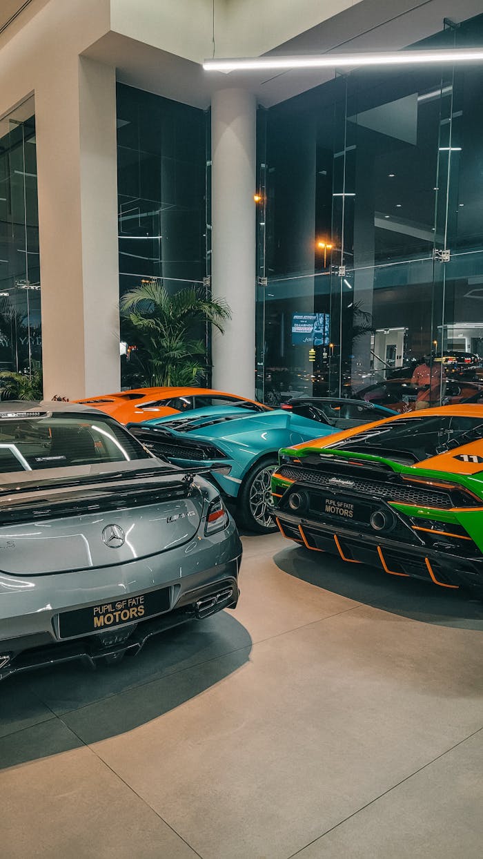 A stylish display of luxury sports cars in a modern car showroom interior.